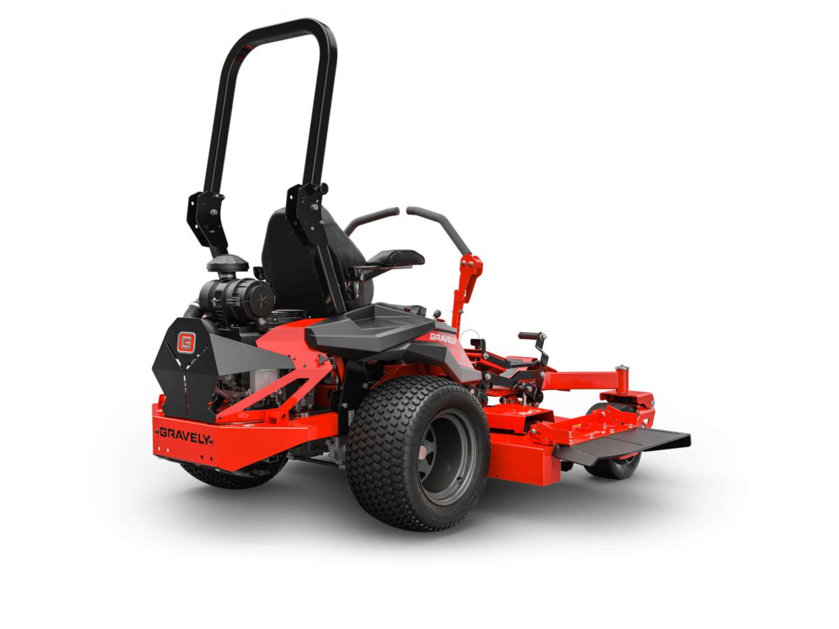 Red riding lawn mower with black seat and roll bar, featuring large tires and engine at the back.