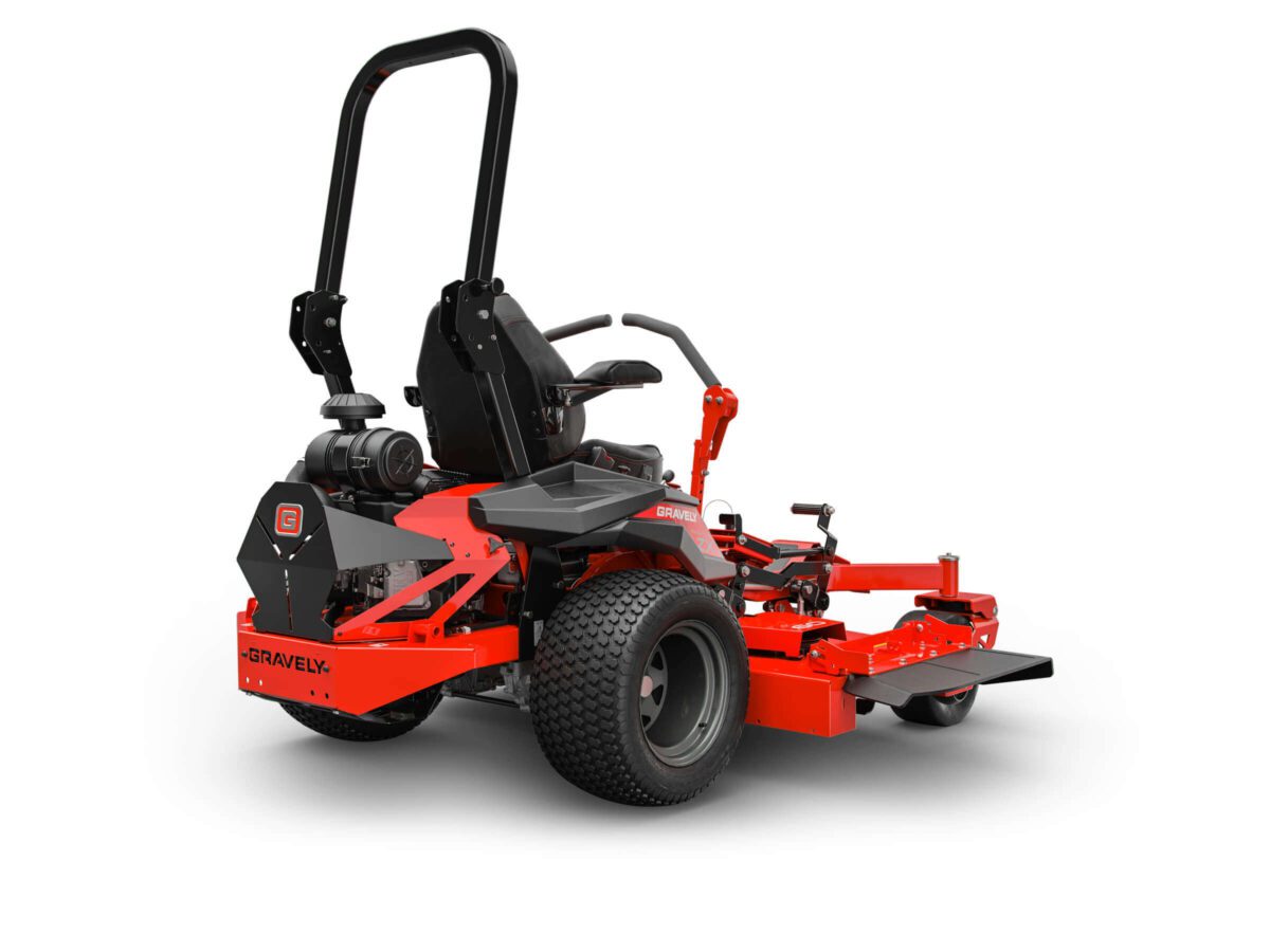 A red lawn mower with large rear wheels, a black seat, and a roll bar, featuring levers for steering and control.