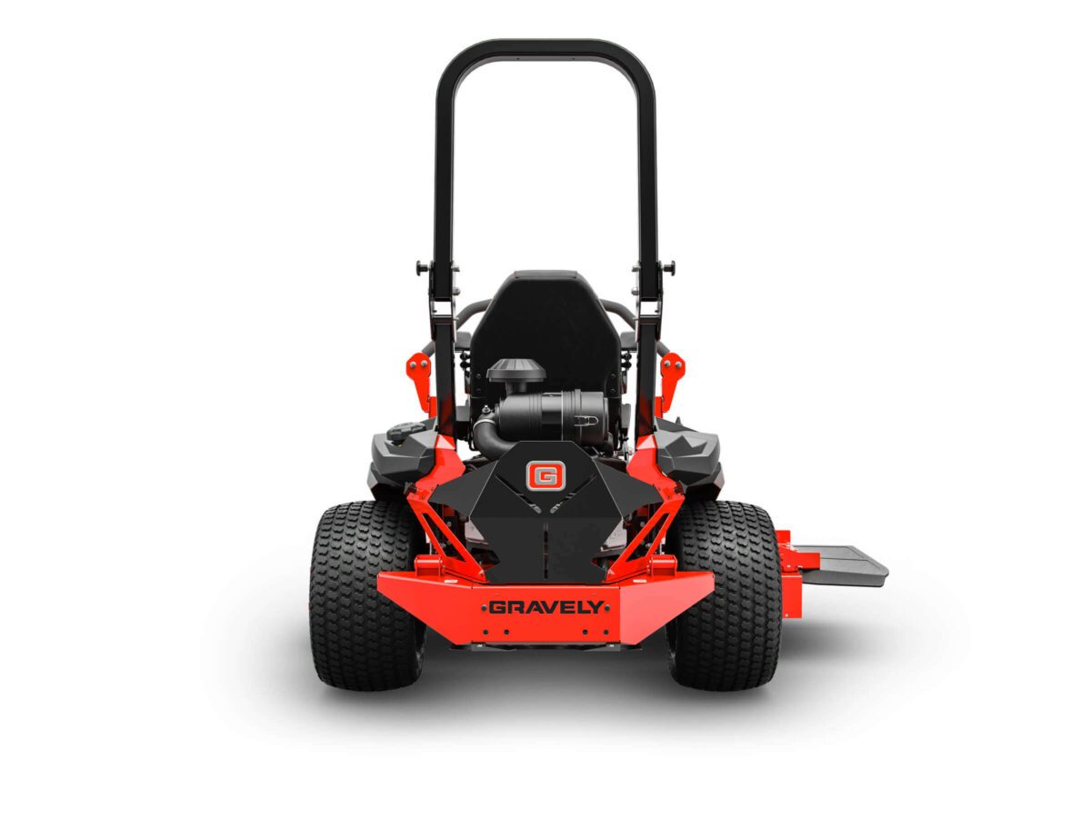 A red and black Gravely lawn mower viewed from the back, featuring a large seat, handlebars, and four wide tires.