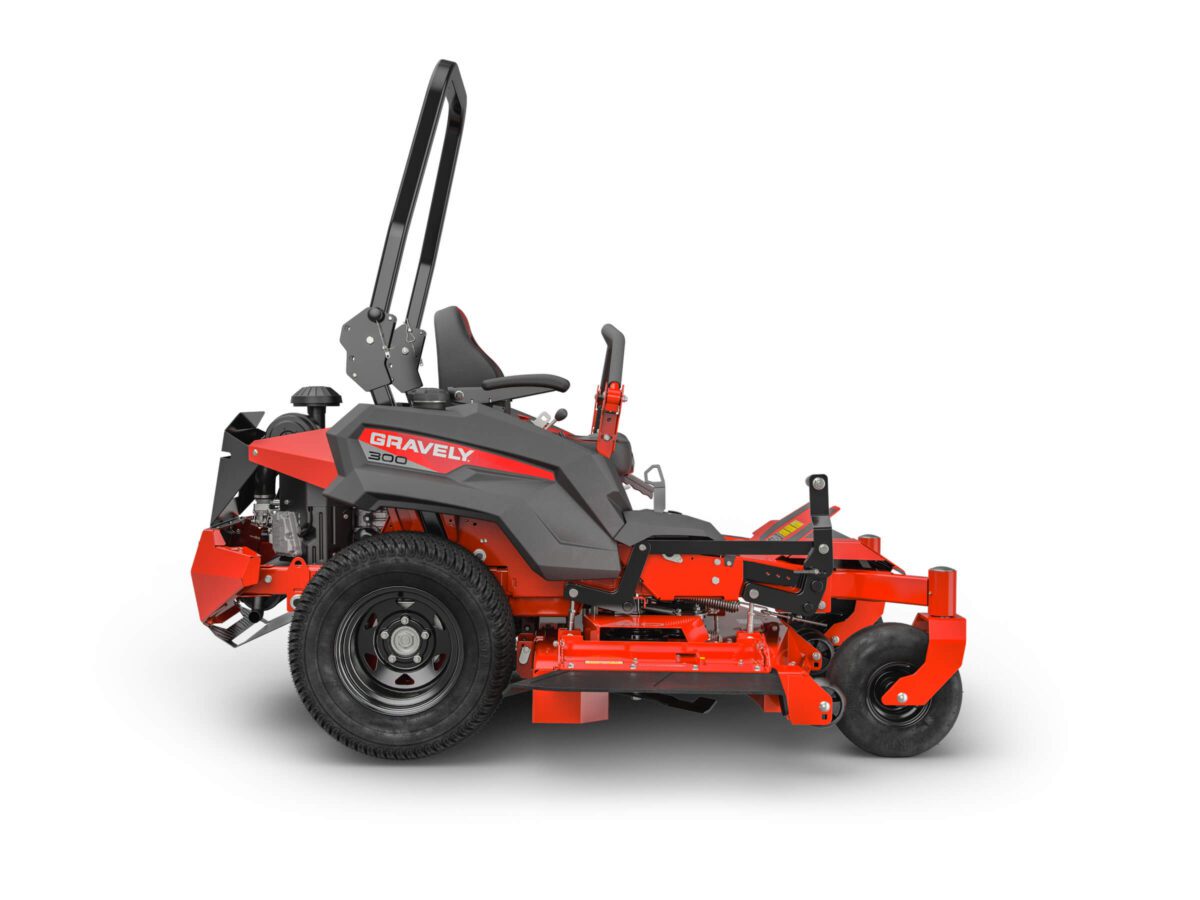 A red Gravely zero-turn lawn mower, side view. It features a seat, steering levers, and a roll bar.