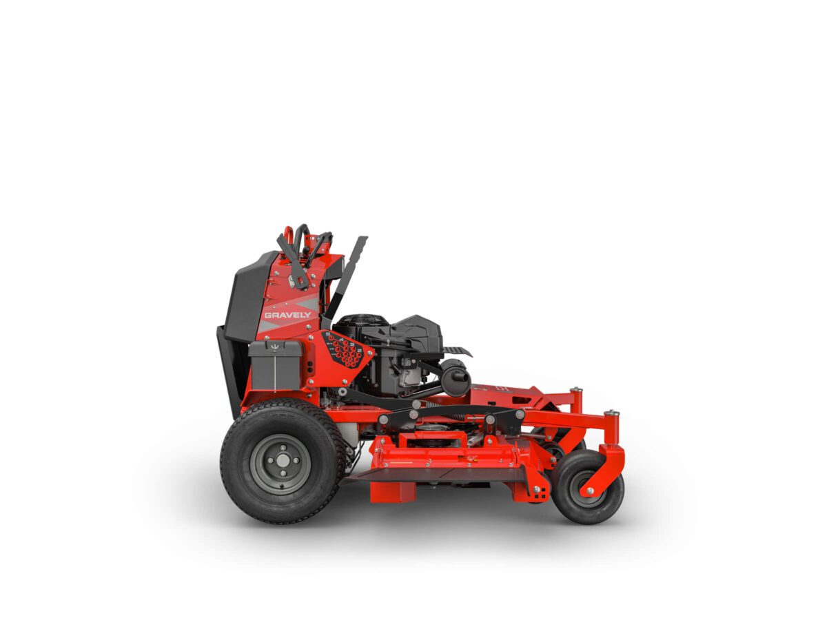 Red commercial lawn mower with large rear wheels and smaller front wheels, featuring a standing platform for the operator. The brand name "Gravely" is displayed on the side.