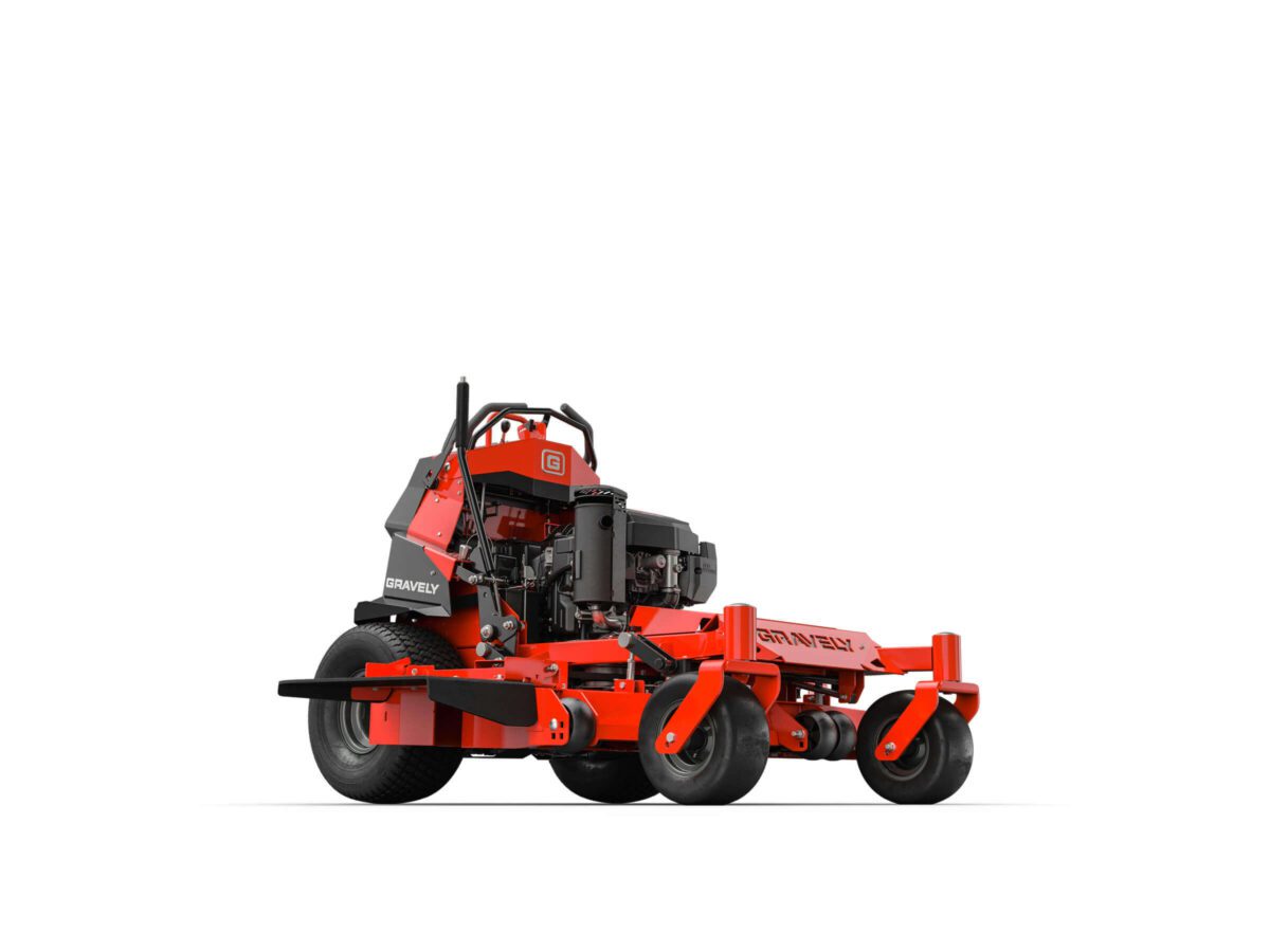 Red and black lawn mower with large wheels on a plain white background, viewed from a low angle.