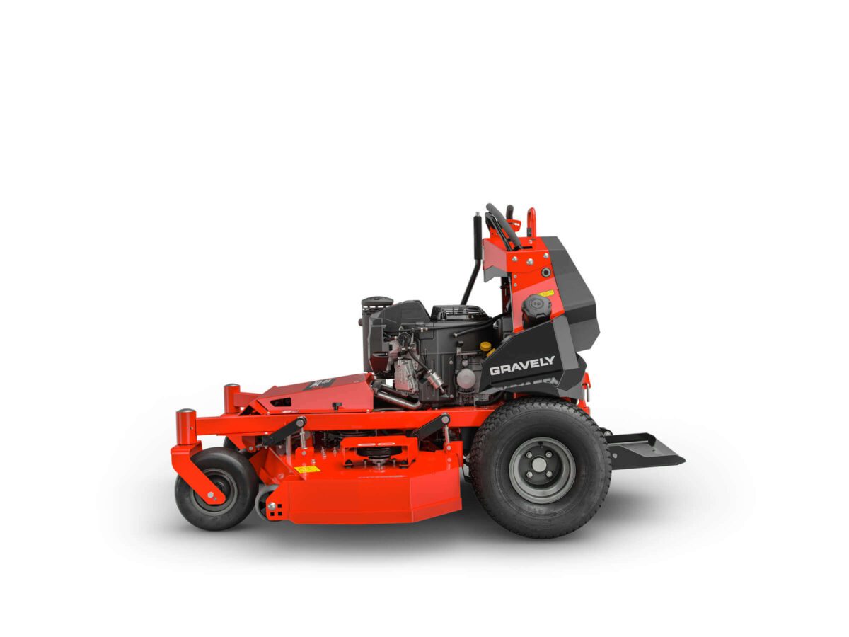 A red Gravely stand-on lawn mower with large rear tires and a visible engine, shown from the side on a white background.