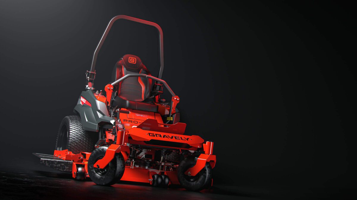 A red and black Gravely zero-turn lawn mower on a dark background, featuring large rear wheels and a protective roll bar.