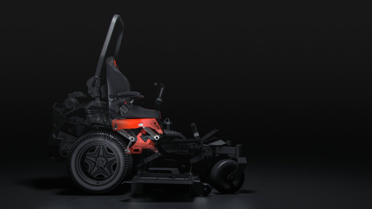 A side view of a black and red riding lawn mower on a dark background, highlighting its seat, steering controls, and large rear wheels.