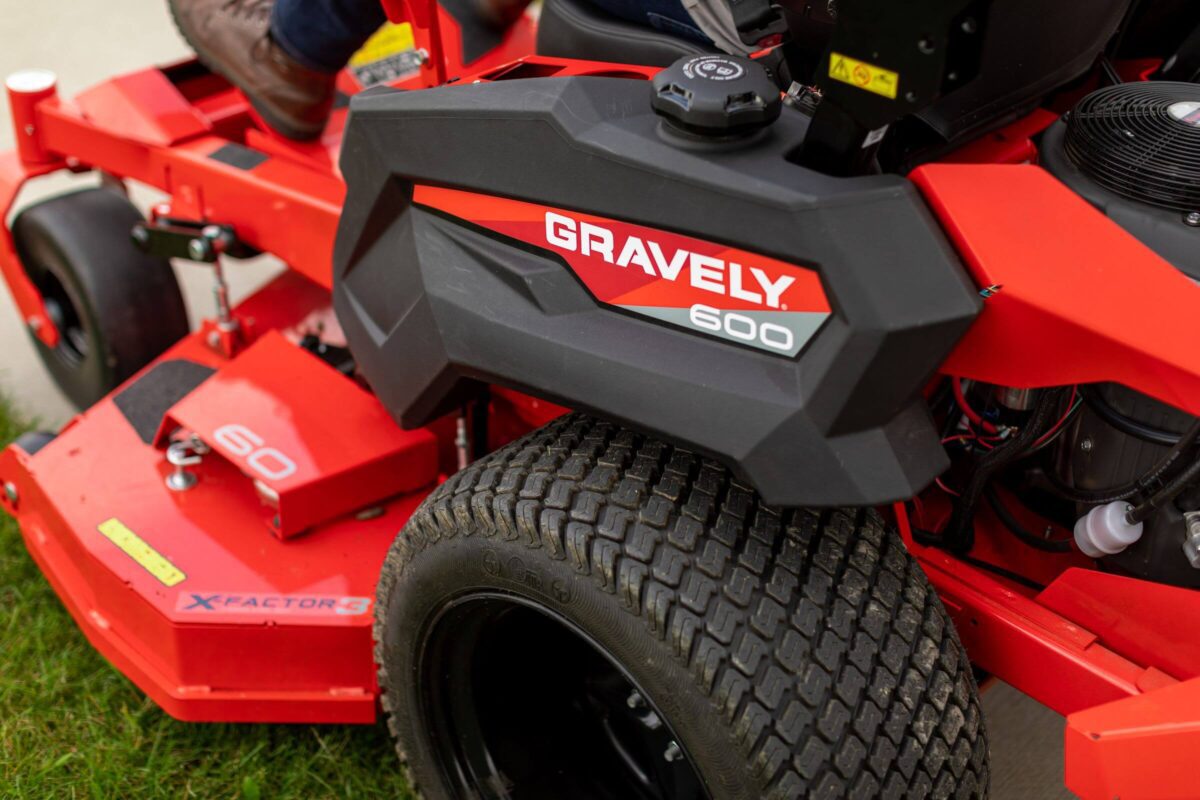 Close-up of a red Gravely 600 lawn mower with visible branding and a large front wheel on grass.