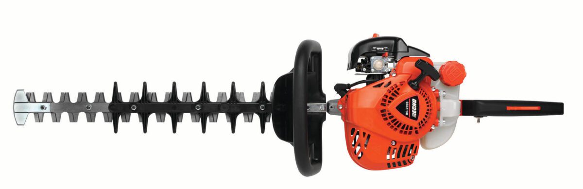 Red and black gas-powered hedge trimmer with a silver cutting blade and protective guard, viewed from the side.