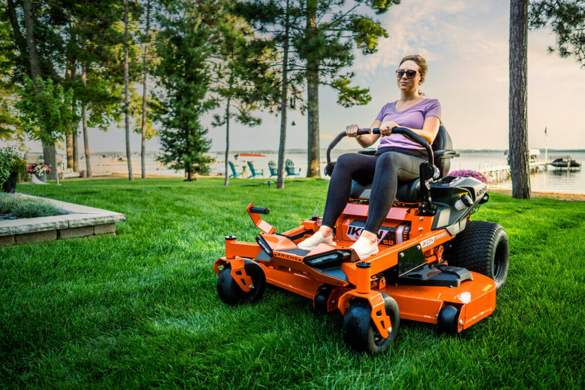 person mowing with ariens ikon lawn mower