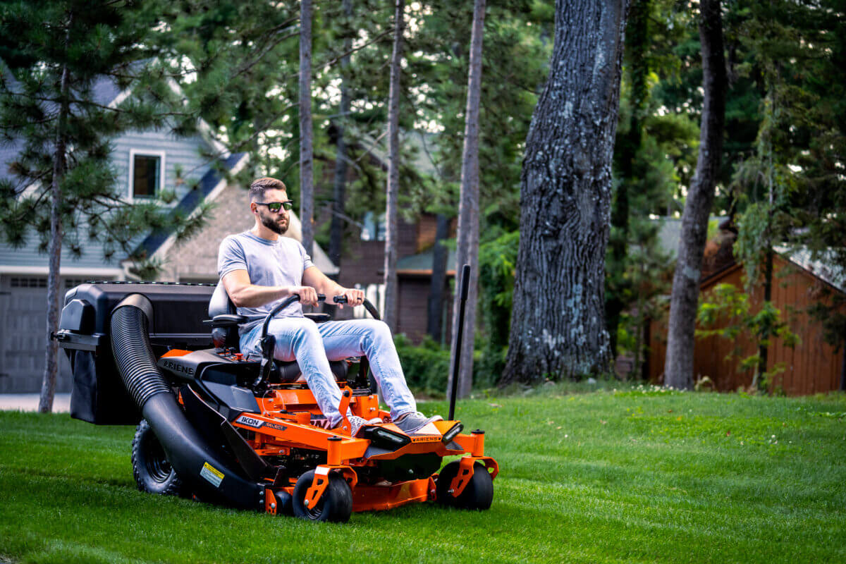 person driving the ikon series ariens lawn mower