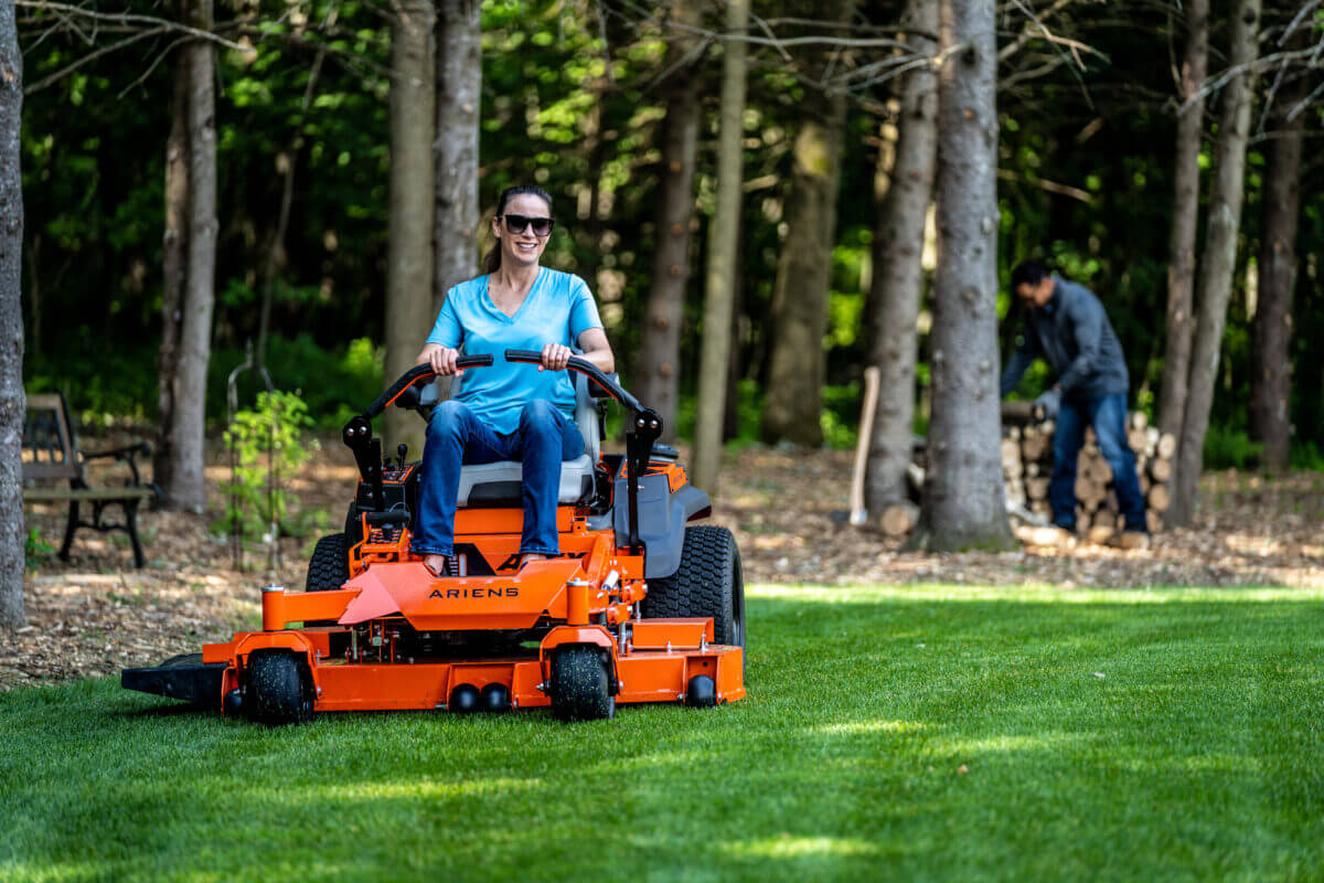 woman cutting grass with the mower