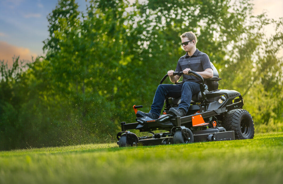 person mowing with ikon series mower